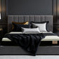 Gray upholstered bed featuring the best mattress for hip, shoulder, and back pain in a luxuriously decorated bedroom.